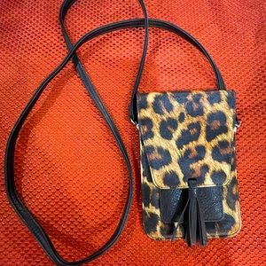 Small leather cross body bag with room for phone and credit cards.